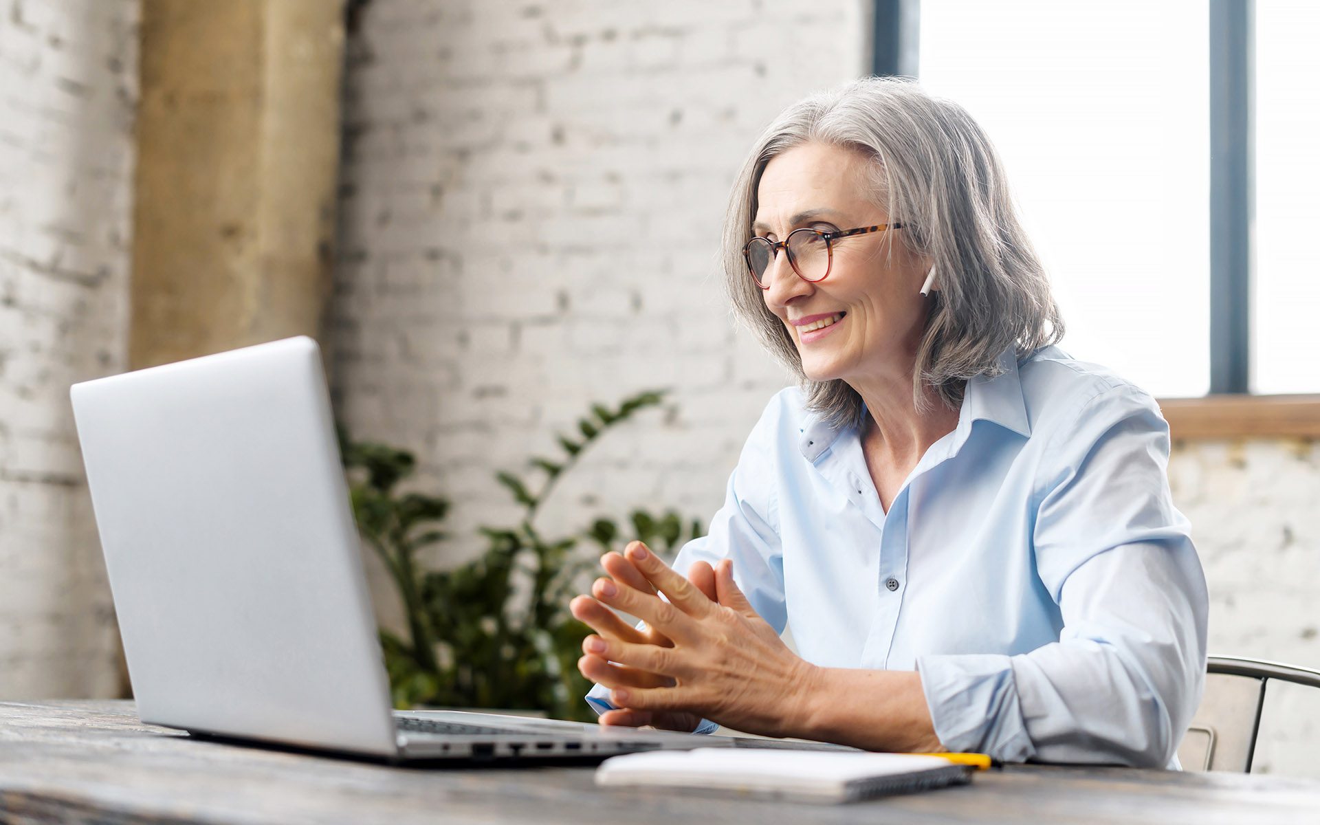 Landing Page #3 - Older Professional Using a Laptop to Run a Meeting